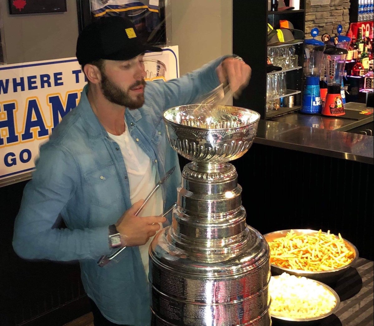 St. Louis Blues defenceman Joel Edmundson chows down on poutine from the Stanley Cup. 