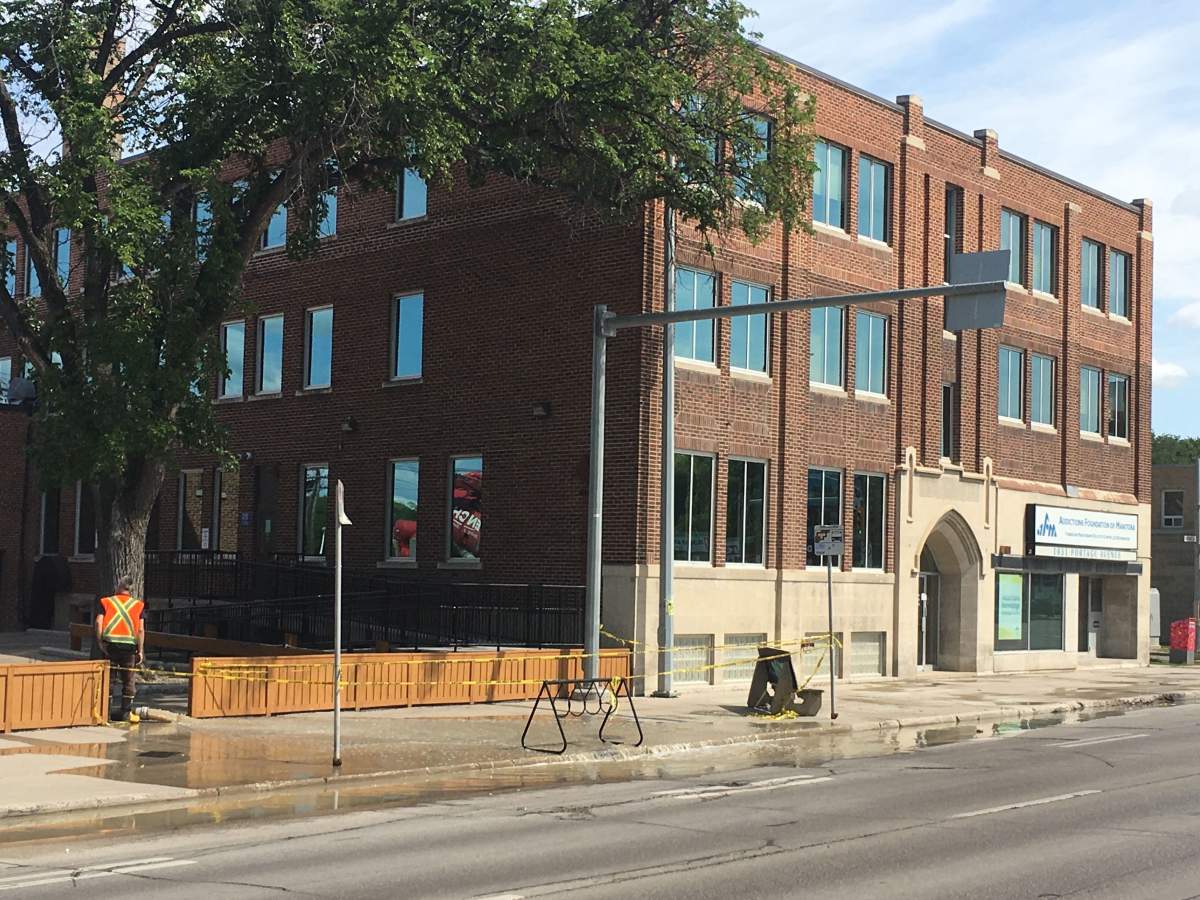 The front of a building with severe flood damage on Portage Avenue.