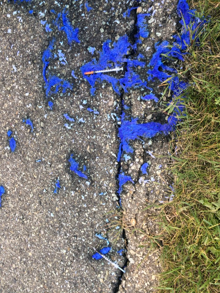 Needles on the pavement.