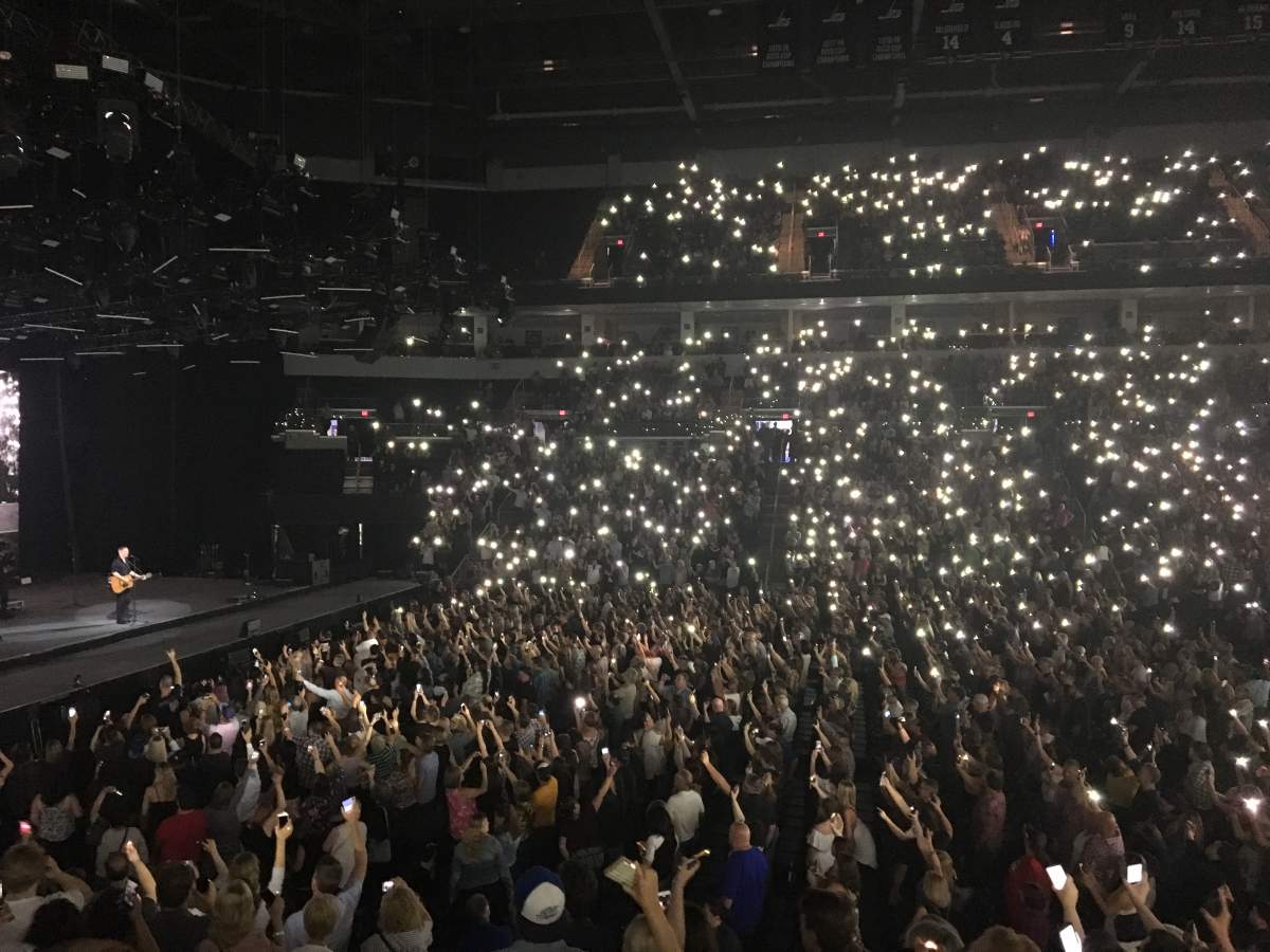 The crowd at Bell MTS Place holds their hold up as Adams plays ‘Shine A Light’.