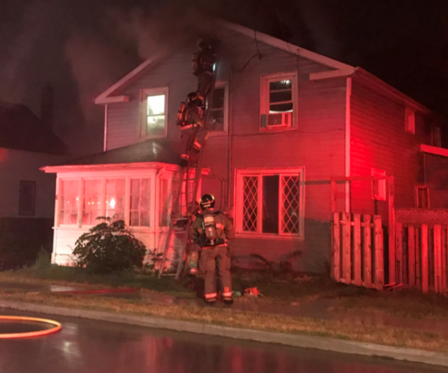 Belleville firefighters are calling a man and his dog heroes after they alerted people inside a burning building to exit the home.