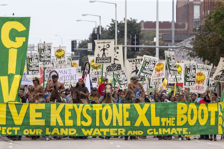 In this Aug. 6, 2017, file photo, demonstrators against the Keystone XL pipeline march in Lincoln, Neb. 