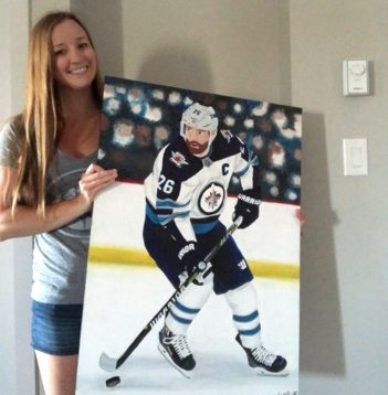 Kylie Pantel and her painting of Winnipeg Jets captain Blake Wheeler. 