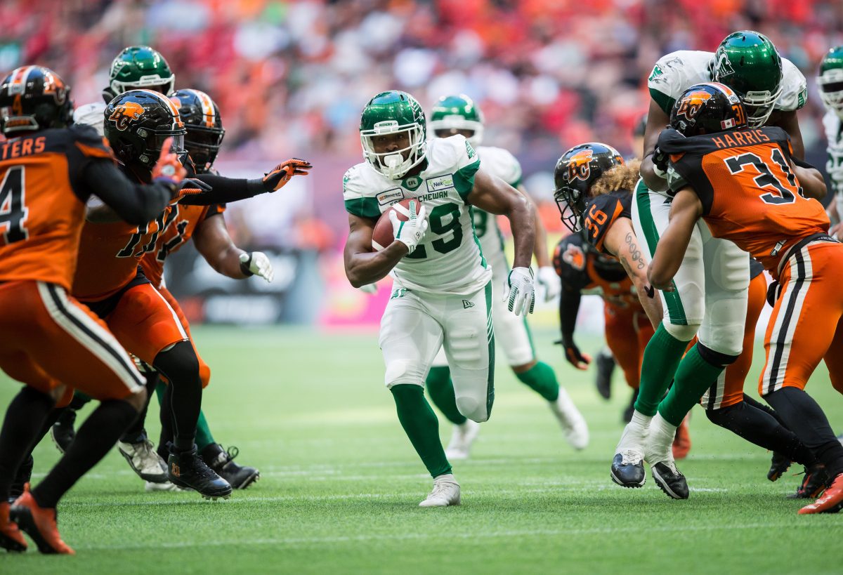 Saskatchewan Roughriders' William Powell, centre, runs the ball during the second half of a CFL football game against the B.C. Lions, in Vancouver, on Saturday July 27, 2019. 