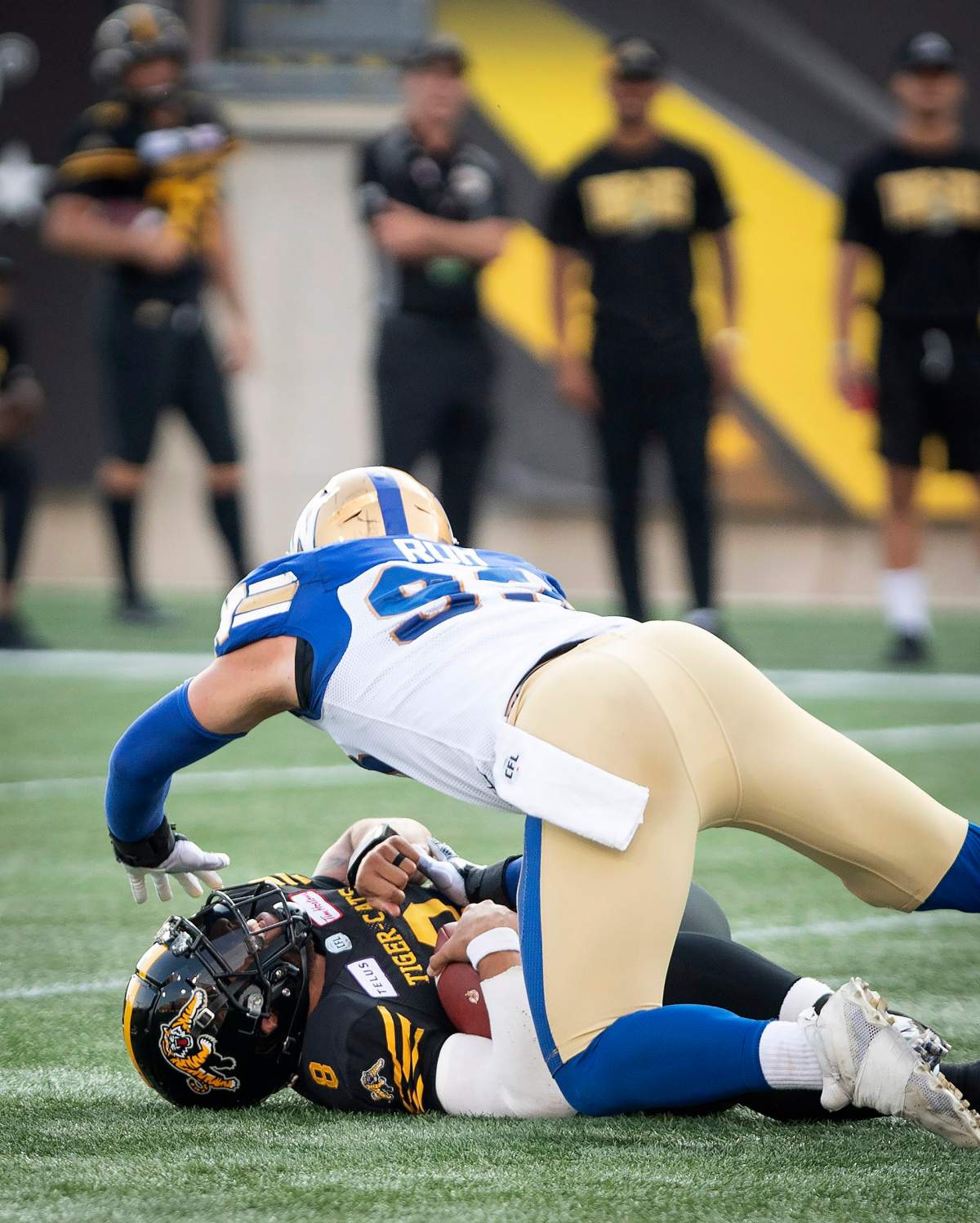 Winnipeg Blue Bombers defensive lineman Craig Roh goes over Hamilton Tiger-Cats quarterback Jeremiah Masoli during first half of game at Tim Hortons Field.