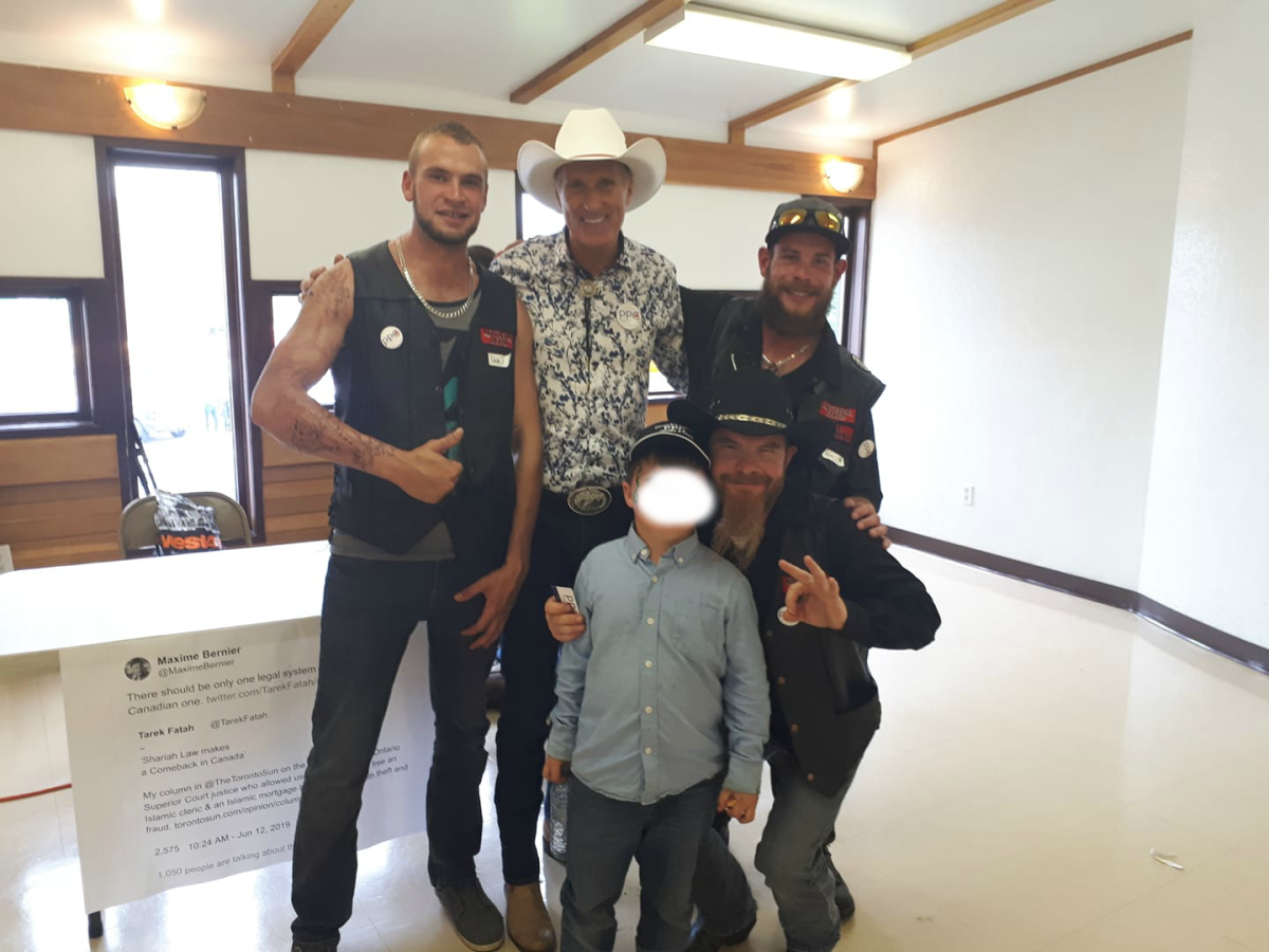 People’s Party of Canada leader Maxime Bernier, in white cowboy hat, poses with members of the Northern Guard in a Facebook photo.
