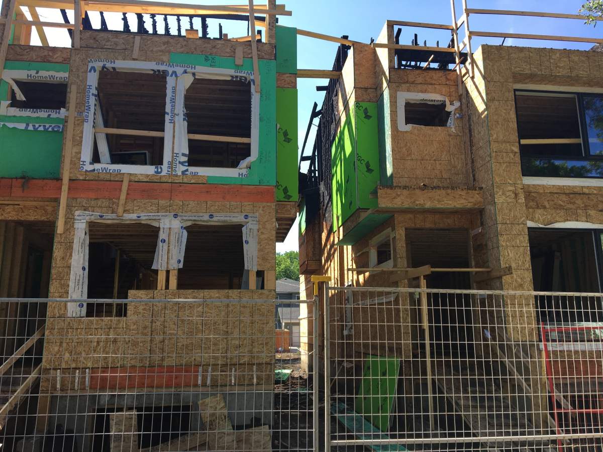 The Wednesday daytime aftermath of a fire at two infill homes on 75 Avenue near 112 Street in Edmonton’s McKernan neighbourhood on Tuesday, July 16, 2019.