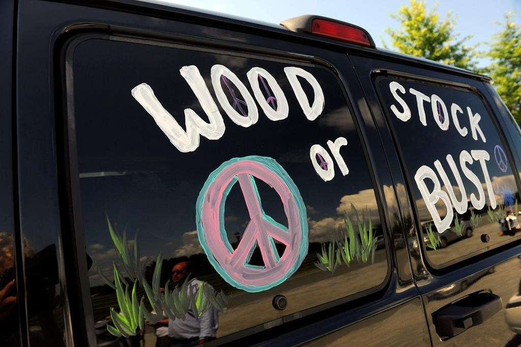 This Aug. 14, 2009 file photo shows a van decorated with “Woodstock or Bust” at the original Woodstock Festival site in Bethel, N.Y. Woodstock 50 is officially cancelled.