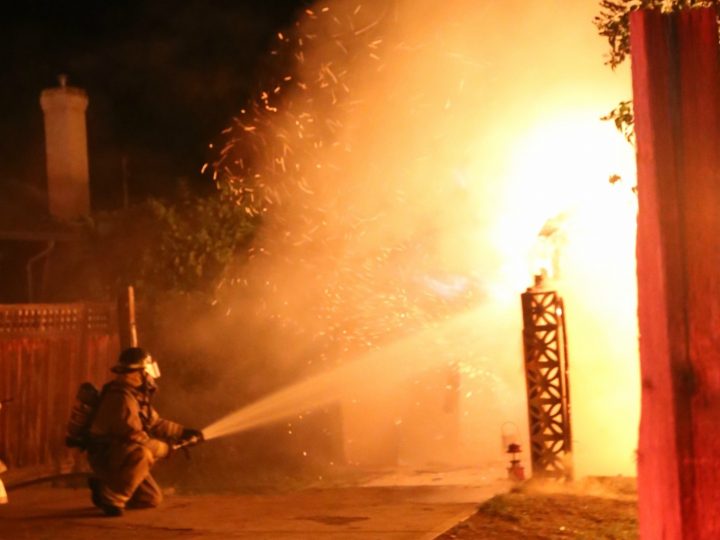 Flames shooting out of the abandoned home on Earle Crescent in Oliver.