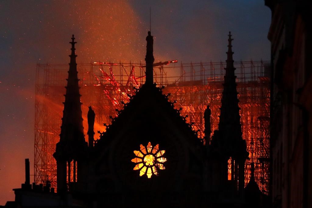 Flames and smoke rise from Notre Dame cathedral as it burns in Paris, April 15, 2019.
