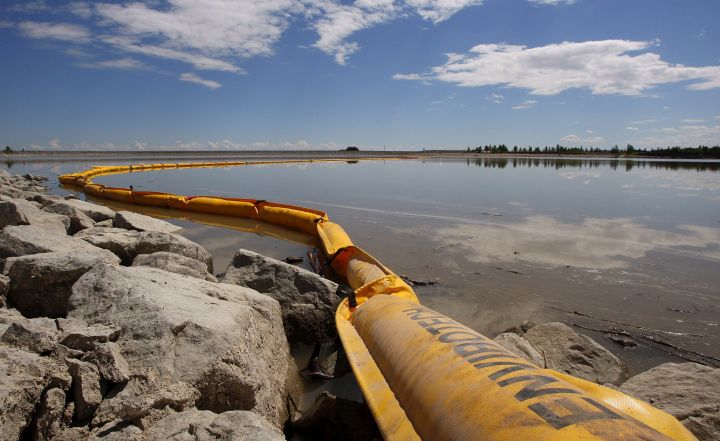 A boom stretches out to contain a pipeline leak on the Gleniffer reservoir near Innisfail, Alta., Tuesday, June 12, 2012. Plains Midstream Canada says one of their non-functioning pipelines leaked between 1,000-3,000 barrels of sour crude near Sundre, Alberta, on June 7 and flowed downstream in the Red Deer river to the reservoir. 