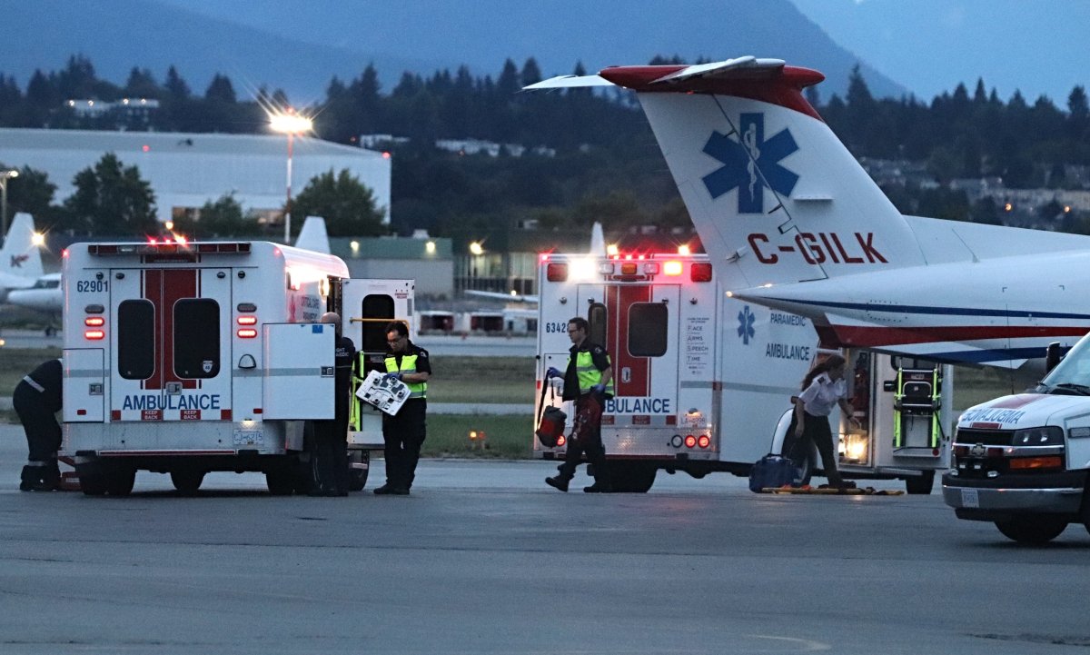 Paramedics at Vancouver International Airport unload two survivors of a float plane crash north of Vancouver Island on Friday, July 26, 2019.