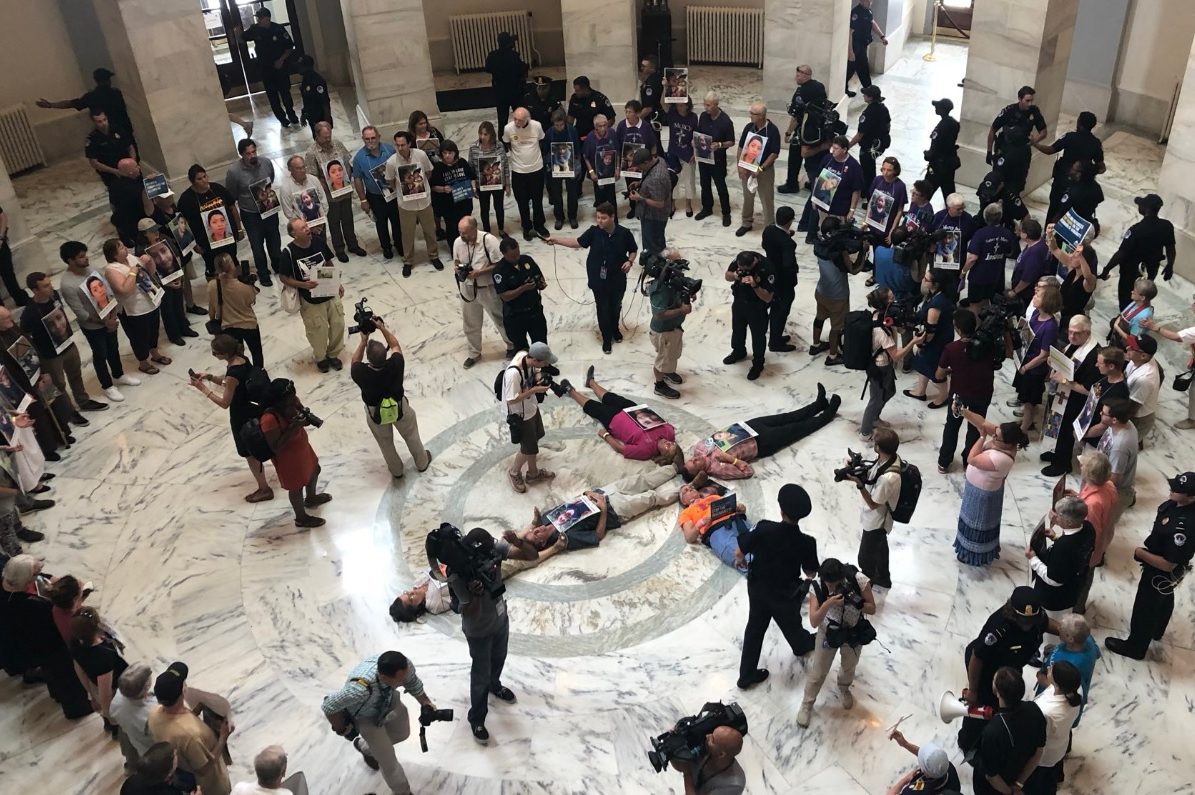 Police arrive to arrest Catholics protesting against the treatment of child migrants in the U.S. 