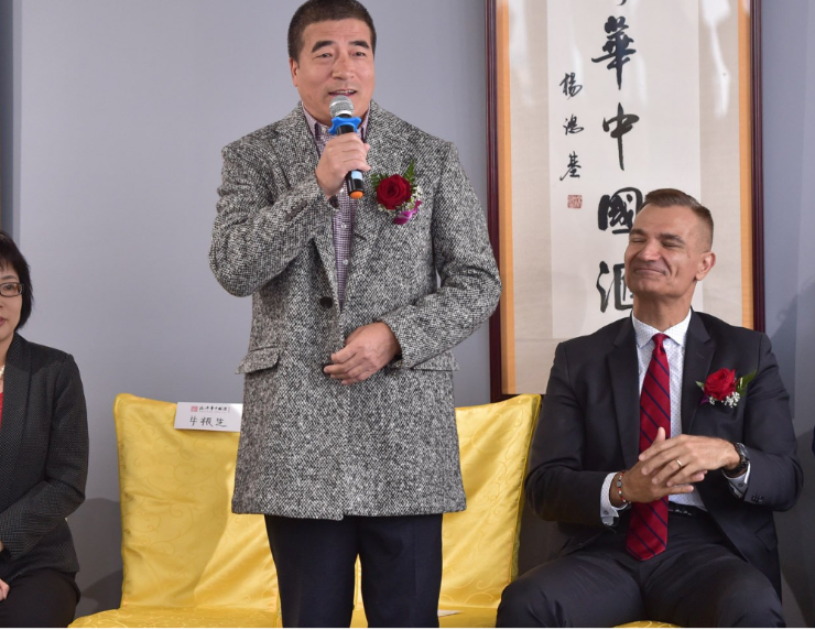 Rongxiang Yuan gives a speech at the opening of a Chinese cultural club, as MP Joe Peschisolido looks on.