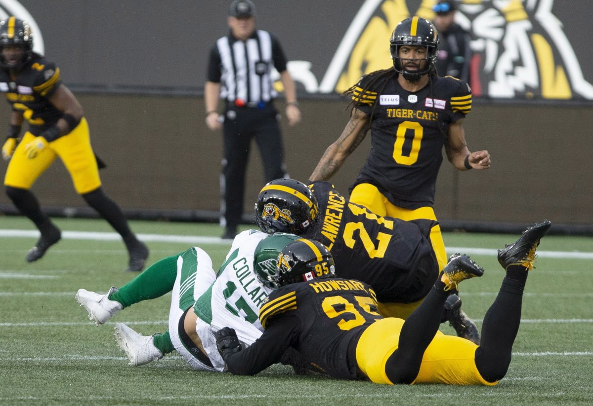 Saskatchewan Roughriders quarterback Zach Collaros is hit late by Hamilton Tiger-Cats' Simoni Lawrence after Collaros was downed by Tiger-Cats' Julian Howsare during first half CFL football game action in Hamilton on Thursday, June 13, 2019.