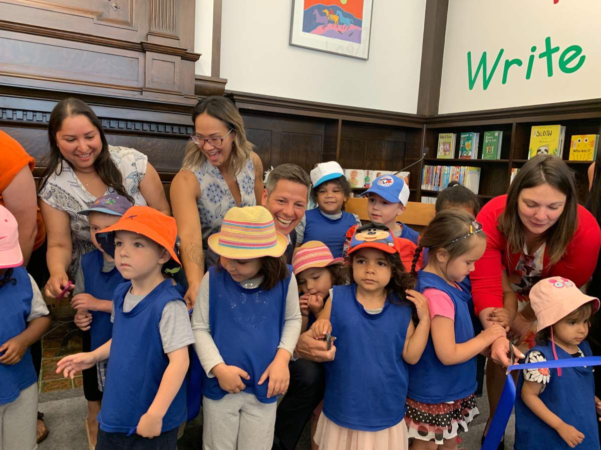 Winnipeg mayor Brian Bowman and colleagues from city hall share laughs with children at Friday's reopening of St. John's Library.