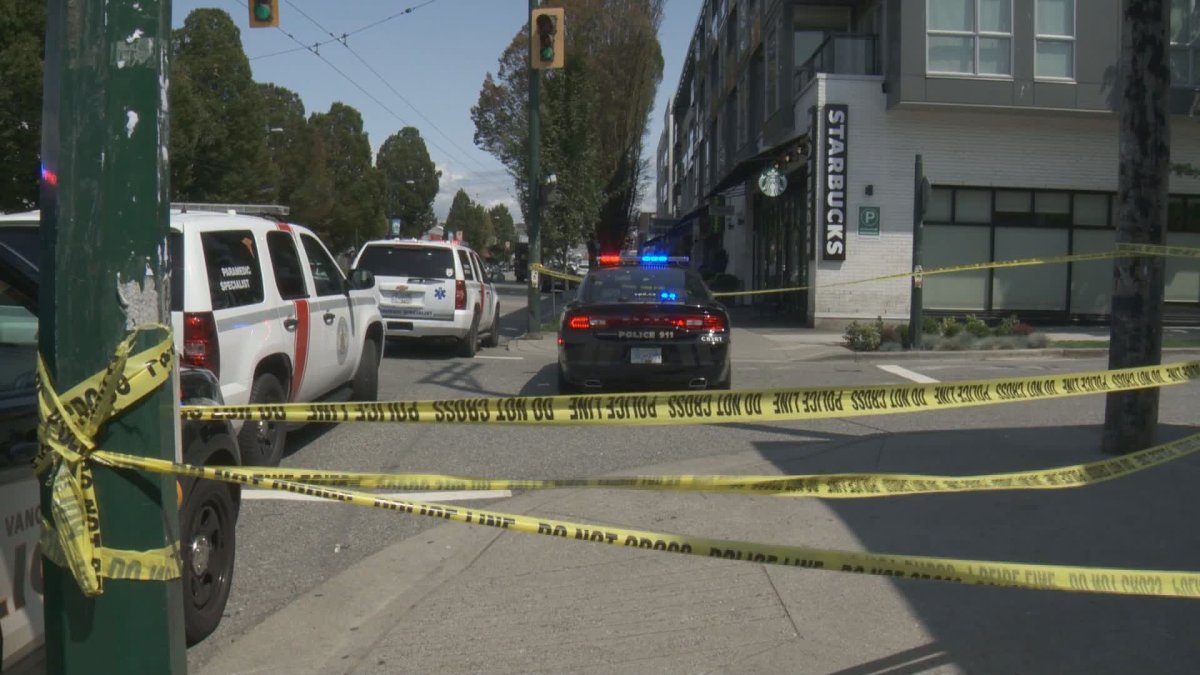Police at the scene of a sudden death at an East Vancouver Starbucks on Friday. 