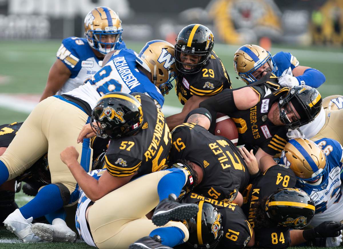 Hamilton Tiger-Cats quarterback Dane Evans (9) gets over the line for a TD against the Winnipeg Blue Bombers during first-half CFL football game action in Hamilton, Ont., on Friday, July 26, 2019.