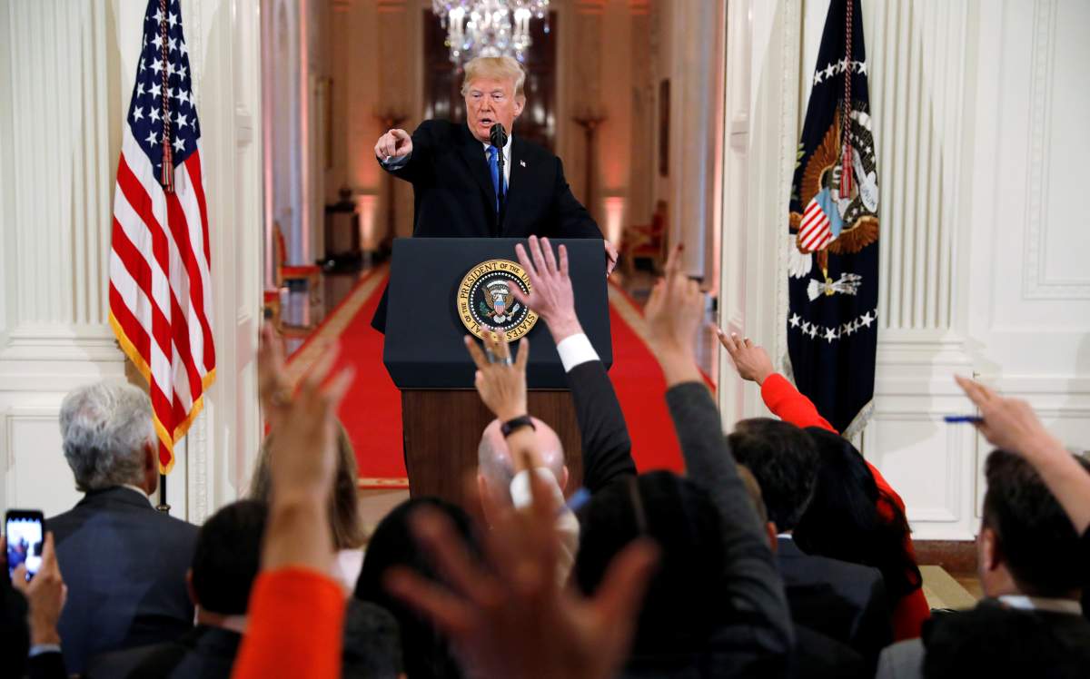U.S.  President Donald Trump points to a questioner while taking questions during a news conference. 