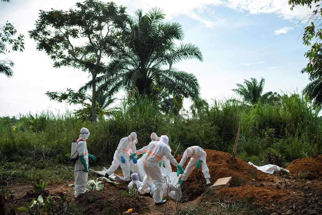 In this Sunday, July 14, 2019 photo, workers bury the remains of Mussa Kathembo, an Islamic scholar who had prayed over those who were sick in Beni, Congo. Kathembo died of Ebola.