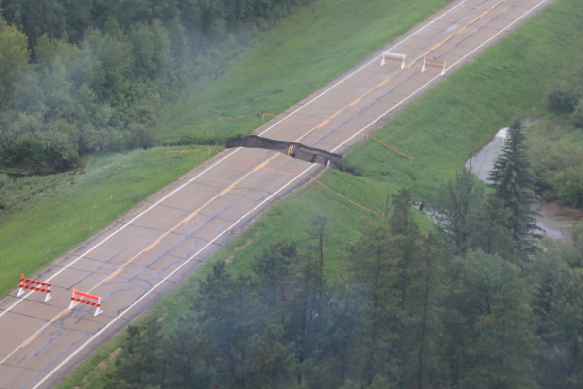 An apparent sinkhole can be seen splitting a closed highway in half in Yellowhead County. 
