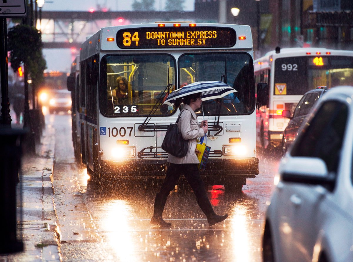 A pedestrian braves heavy rain in Halifax on Friday, Sept. 13, 2013.
