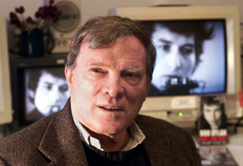 CORRECTS TO FIRST NAME TO FRAZER INSTEAD OF FRANK PENNEBAKER FILE - In this Jan. 27, 2000 file photo, documentary filmmaker D.A. Pennebaker is flanked by 35-year-old images of Bob Dylan as Pennebaker sits in his New York editing suite. Oscar-winning documentary maker Pennebaker has died at the age of 94. Frazer Pennebaker said in an email his father died Thursday, Aug. 1, 2019, at his Long Island home from natural causes. 
