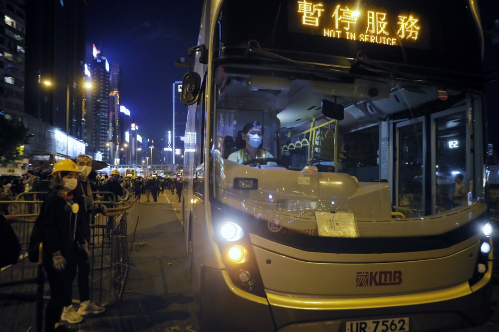 An off duty bus drives pass a barricades by protesters at Causeway Bay to hold the anti-extradition bill protest in Hong Kong, Sunday, Aug. 4, 2019.