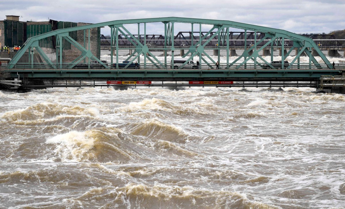 Water crashes against signage and pipes underneath the Chaudiere Bridge close to the bridge deck in Ottawa as water levels on the Ottawa River run high, Tuesday, May 9, 2017.