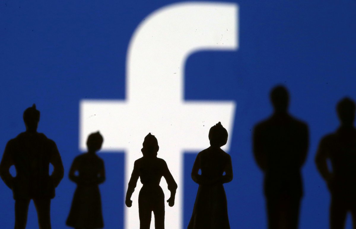 Small toy figures are seen in front of Facebook logo in this illustration picture, April 8, 2019. 