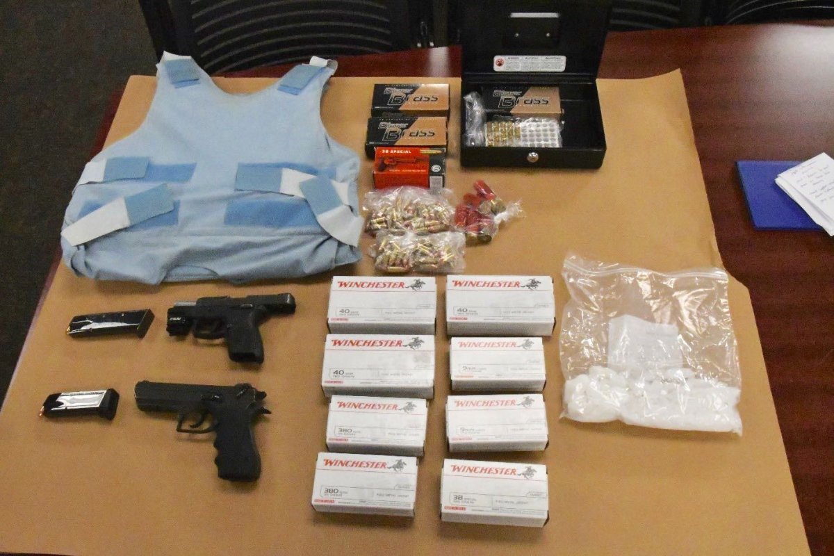Items, including drugs and two loaded firearms, police say they seized from two homes and an SUV on Aug. 21, 2019.