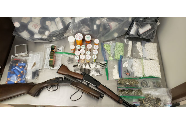 Last week, officers seized a large quantity of illegal substances, several thousands of dollars in Canadian currency and two illegally possessed, loaded firearms, police say.