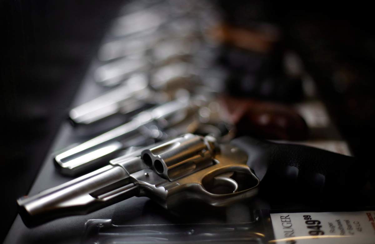 In this photo taken Friday, Dec. 21, 2018, handguns for sale are lined up in a display case at Frontier Justice in Lee's Summit, Mo.