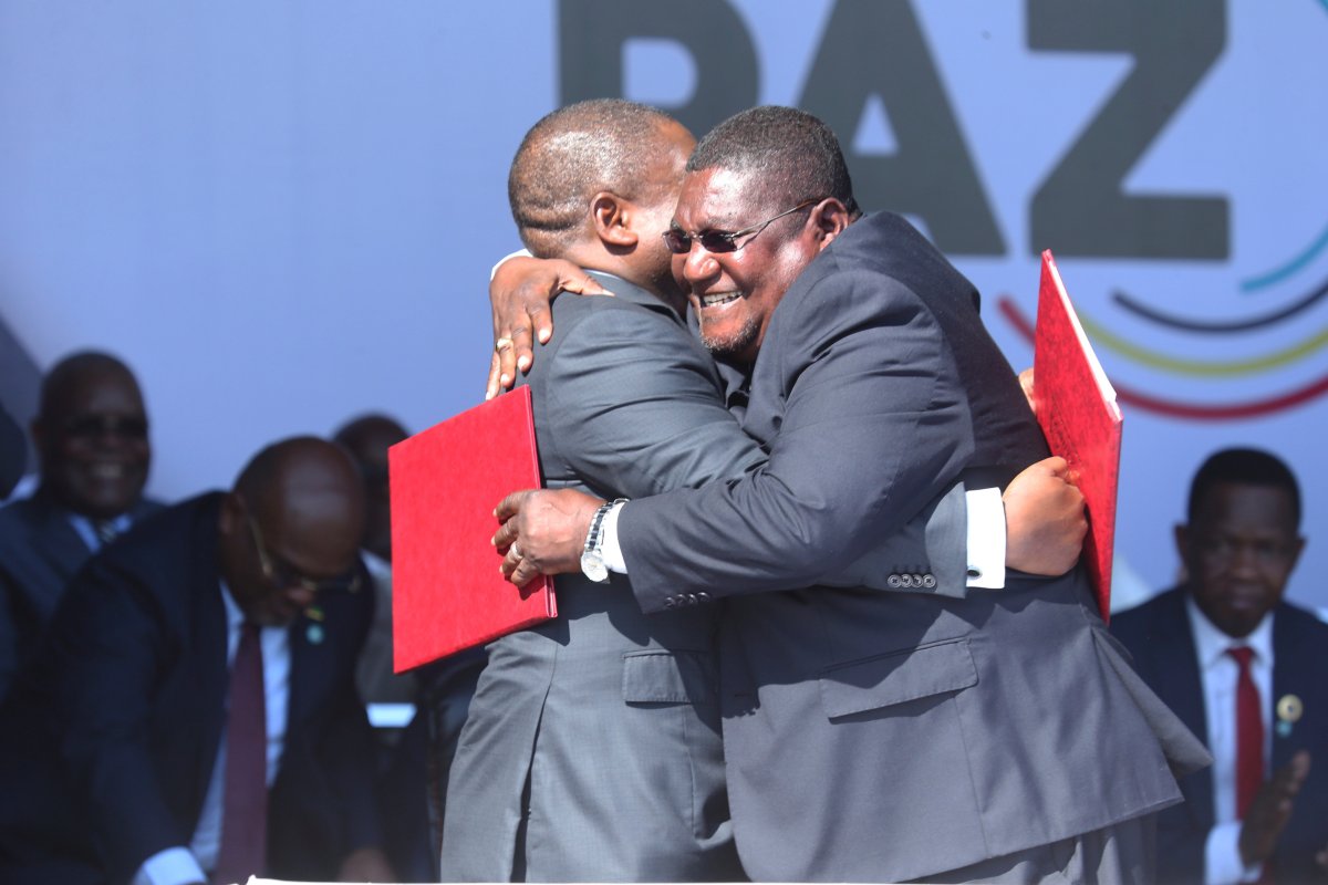 Mozambique President Filipe Nyusi, right, and Renamo leader Ossufo Momade hug each other after signing a peace accord at Gorongosa National Park, about 170 kilometres from Beira, Mozambique, Thursday, Aug, 1, 2019.