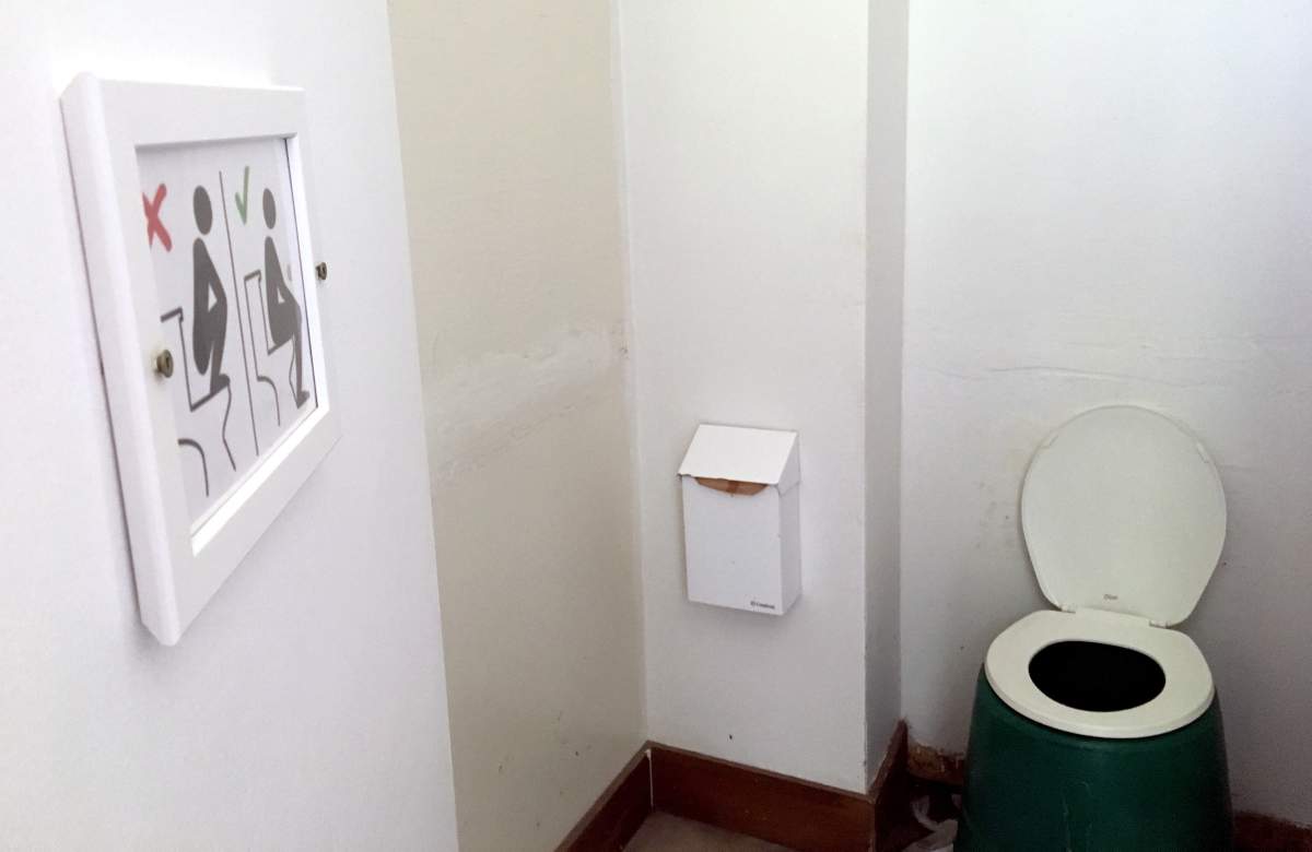 Interior view of an outhouse at the Lake O’Hara parking lot at Yoho National Park in the Rocky Mountains, in eastern British Columbia on July 28, 2019. Some new signs are popping up in the Canadian Rockies to show international visitors how to properly use the outhouses. Staff at Lake O’Hara in Yoho National Park installed toilet etiquette signs in the bathroom facilities in June.