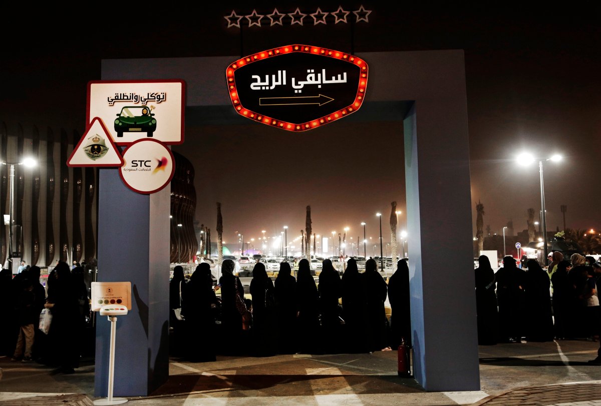 FILE - In this June 22, 2018, file photo, women wait in line to ride go carts at a road safety event for female drivers launched at the Riyadh Park Mall in Riyadh.