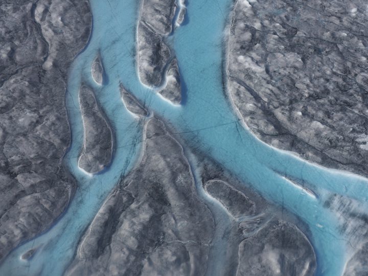 In this image taken on Thursday Aug.1, 2019 large rivers of melting water form on an ice sheet in western Greenland and drain into moulin holes that empty into the ocean from underneath the ice. 