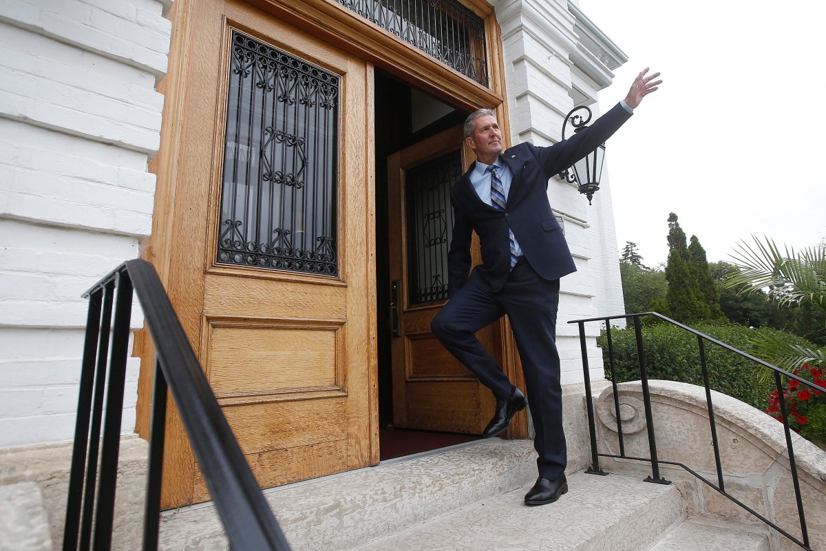 Manitoba Premier Brian Pallister waves as he enters the Lieutenant Governor's home to drop the writ calling for a September election in Winnipeg Monday, August 12, 2019.