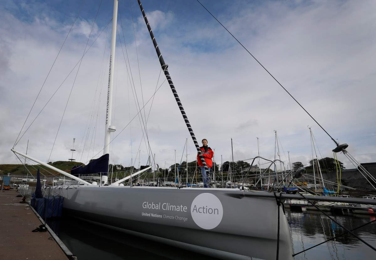Greta Thunberg poses for a picture on the boat Malizia as it is moored in Plymouth, England Tuesday, Aug. 13, 2019. Greta Thunberg, the 16-year-old climate change activist who has inspired student protests around the world, is heading to the United States this week – in a sailboat. (AP Photo/Kirsty Wigglesworth)
