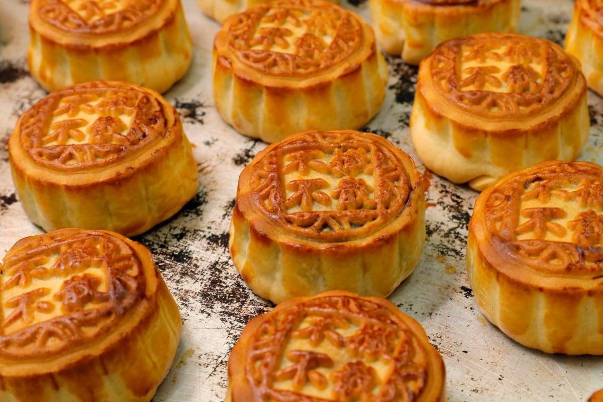 In this Aug. 9, 2019 photo, mooncakes with Chinese words “No withdrawal, no dispersal” are placed on the table at Wah Yee Tang bakery in Hong Kong. (AP Photo/Kin Cheung)
