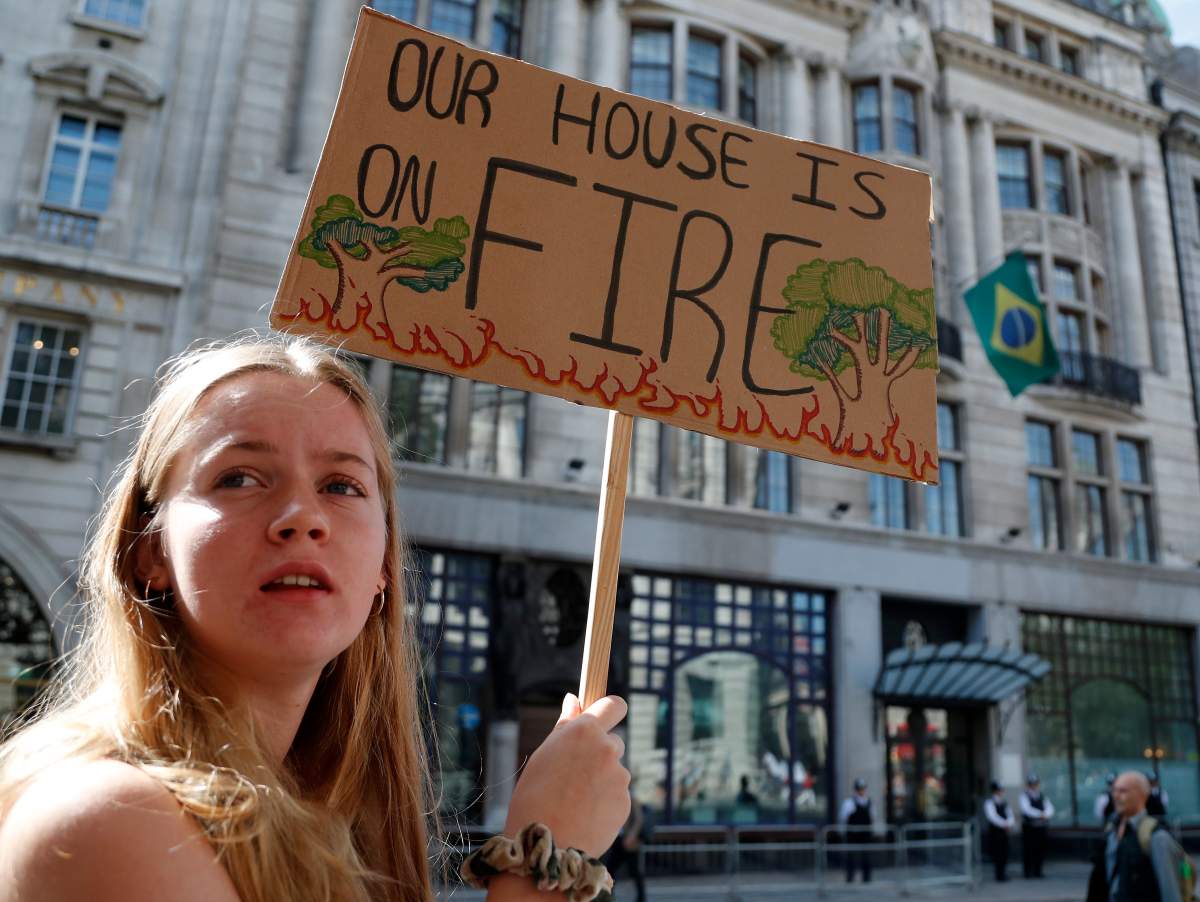 Extinction Rebellion activists protest outside the Brazilian Embassy in London, Friday, Aug. 23, 2019, to call on Brazil’s President Jair Bolsonaro to act to protect the Amazon rainforest. (AP Photo/Frank Augstein)
