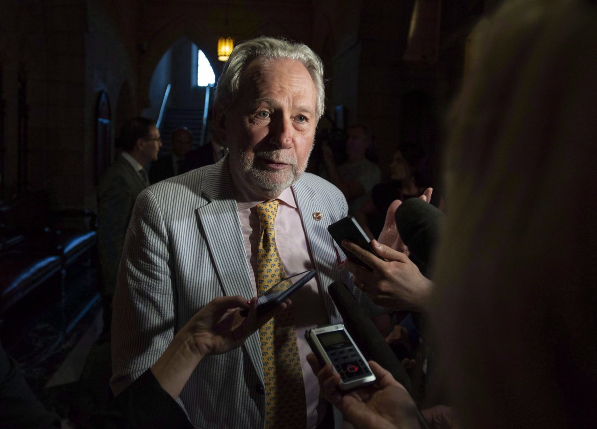 Sen. Peter Harder, Government Representative in the Senate, speaks to reporters on Parliament Hill in Ottawa on Tuesday, June 19, 2018. 