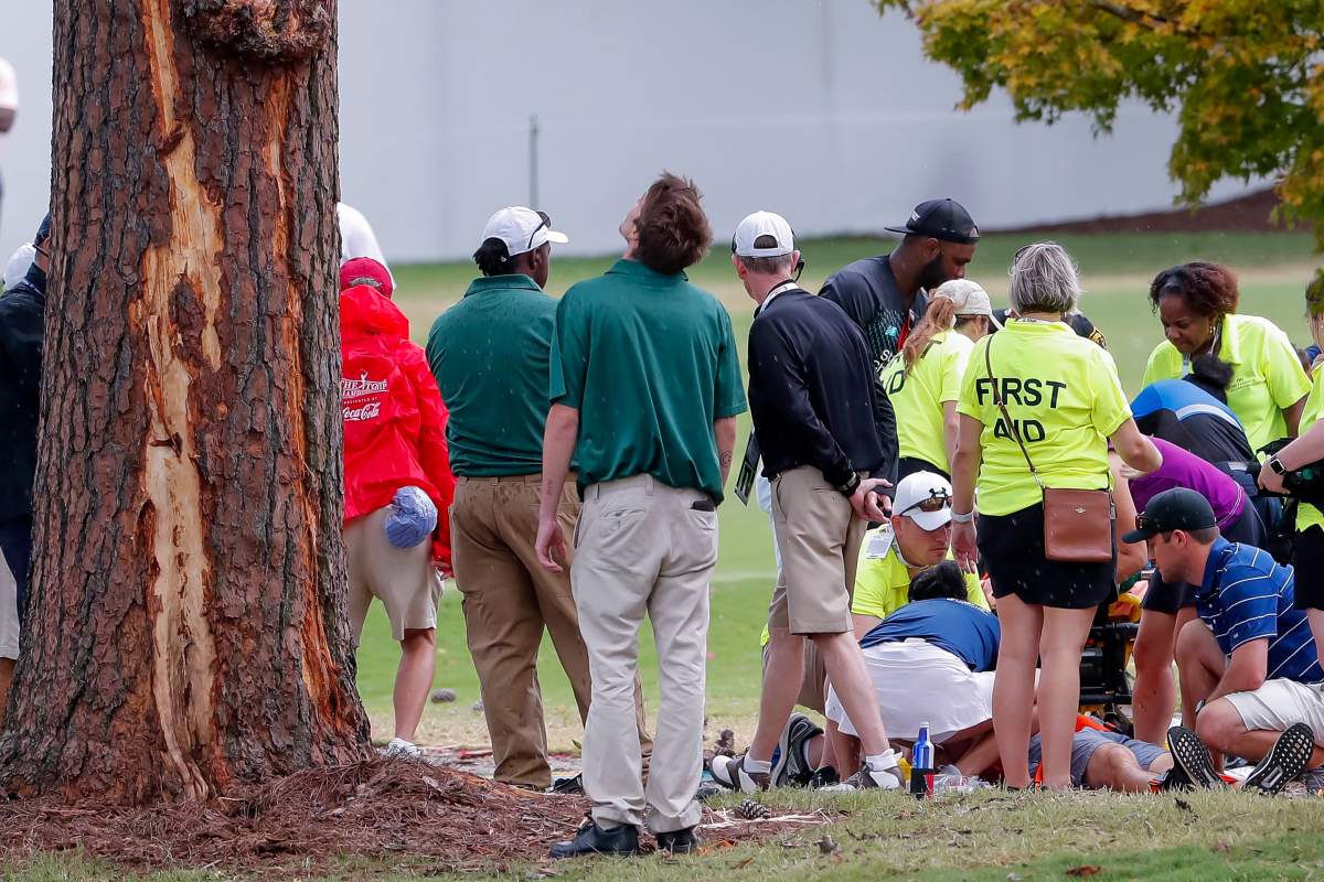 A person is treated by emergency medical personnel after lightning struck a pine tree during a weather delay during the third round of the Tour Championship golf tournament at the East Lake Golf Club in Atlanta, Georgia, USA, 24 August 2019. Several people were treated in the incident. The tournament, which runs through 25 August, is the finale of the FedExCup playoffs.