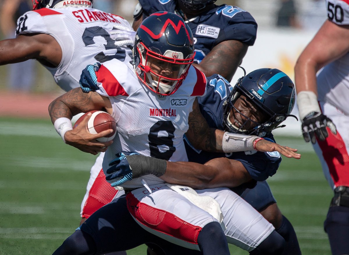 Montreal Alouettes quarterback Vernon Adams Jr. is tackled by Toronto Argonauts Kennan Gilchrist, right, in second half CFL action in Moncton, N.B. on Sunday, Aug. 25, 2019. Montreal won 28-22. 