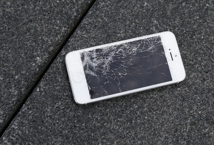 This Aug. 26, 2015 photo shows an Apple iPhone with a cracked screen.