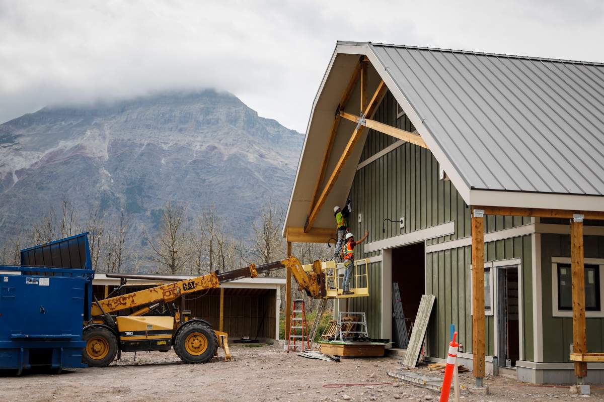 Workers put the finishing touches on Alpine Stables after a wildfire destroyed the original stable two years ago in Waterton National Park, Alta., Friday, Aug. 9, 2019.