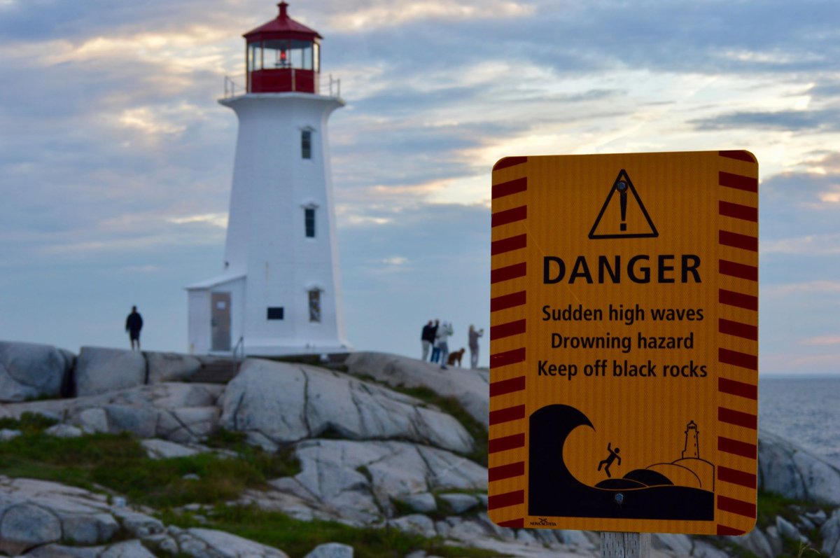 A sign warns visitors about the dangerous waves that can be found at Peggy's Cove in Nova Scotia.