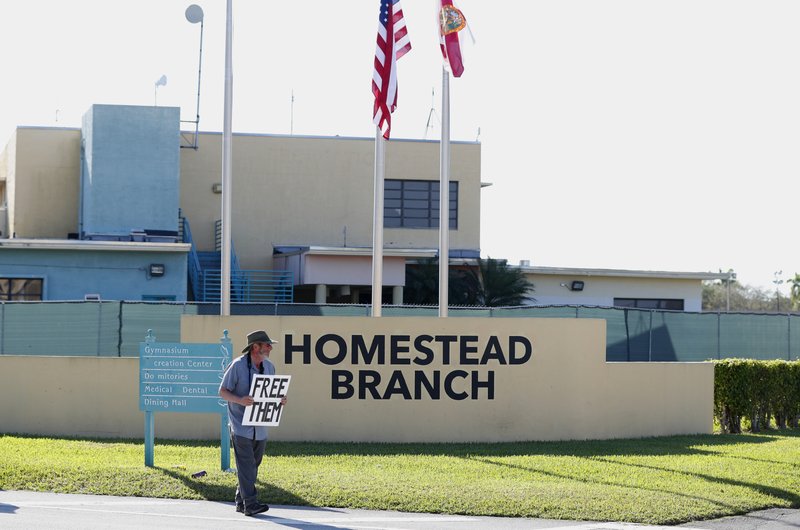 FILE - In this Feb. 19, 2019 file photo, Josh Rubin demonstrates in front of the Homestead Temporary Shelter for Unaccompanied Children, in Homestead, Fla.