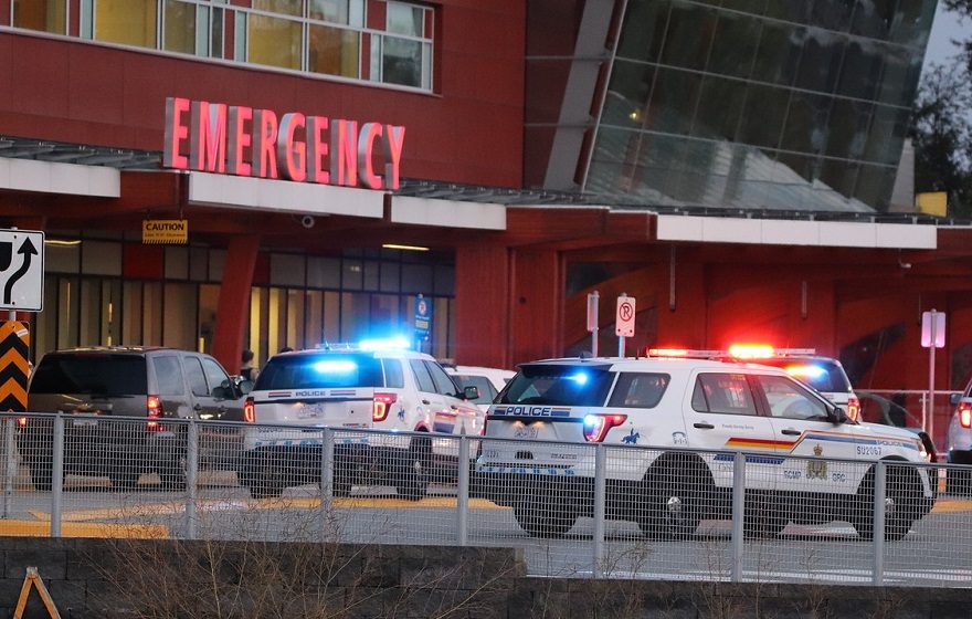 Surrey RCMP descend on the emergency room of Surrey Memorial Hospital after the arrival of a shooting victim Friday, Aug. 23, 2019.