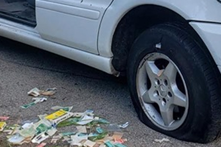 Bandages are shown in near a minivan with two flat tires in Mission Viejo, Calif., on Aug. 20, 2019.